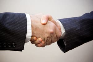 two men shaking hands representing the need for an accessory after the fact lawyer